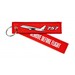 Keyholder with `Remove Before Flight ` on one side and `757`and silhouette on other side