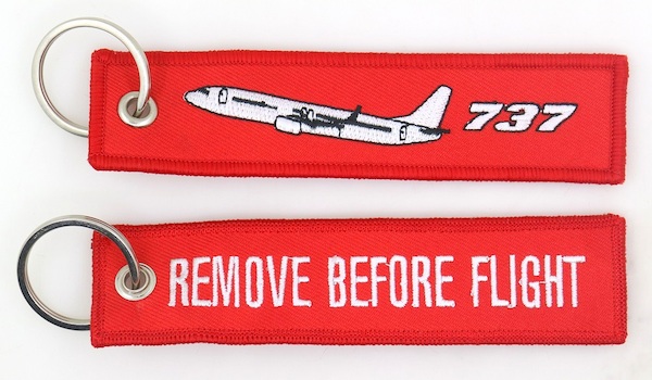 Keyholder with `Remove Before Flight ` on one side and `737`and silhouette on other side RBF-737